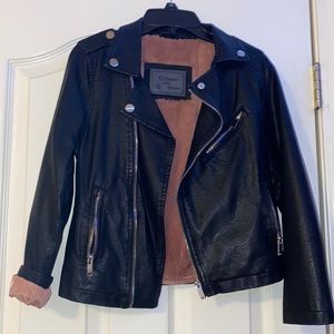 Girls black leather jacket lined with soft pink fur.